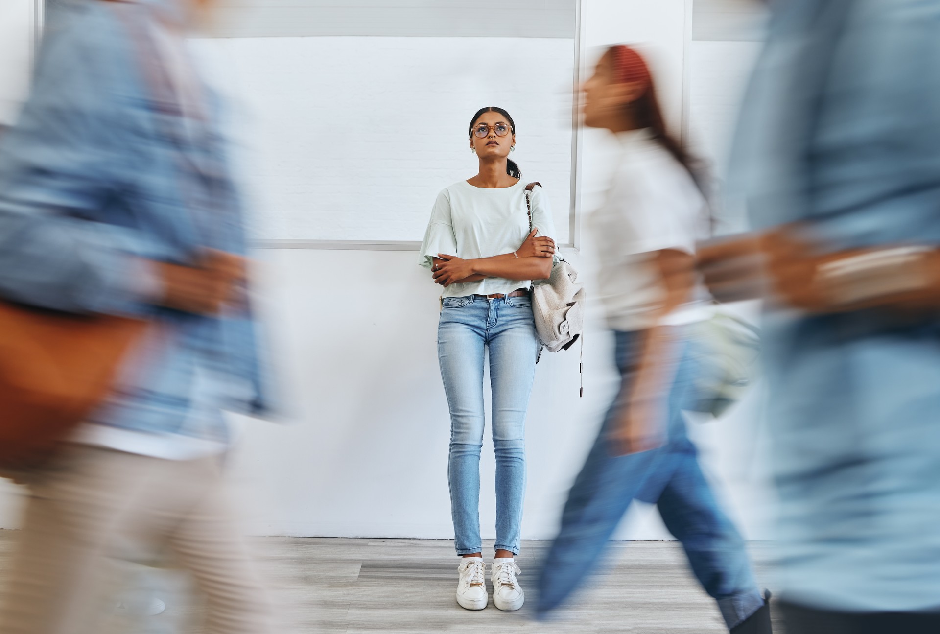 Student, anxiety and woman in busy college campus with depression, sad and mental health problems. Burnout, stress and tired girl thinking about exam, assignment or project deadline at university